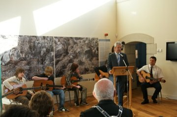 Rod introduces the piece of music commissioned from James Crisp (on the right) and the guitar group drawn from Ysgol Dewi Sant.
